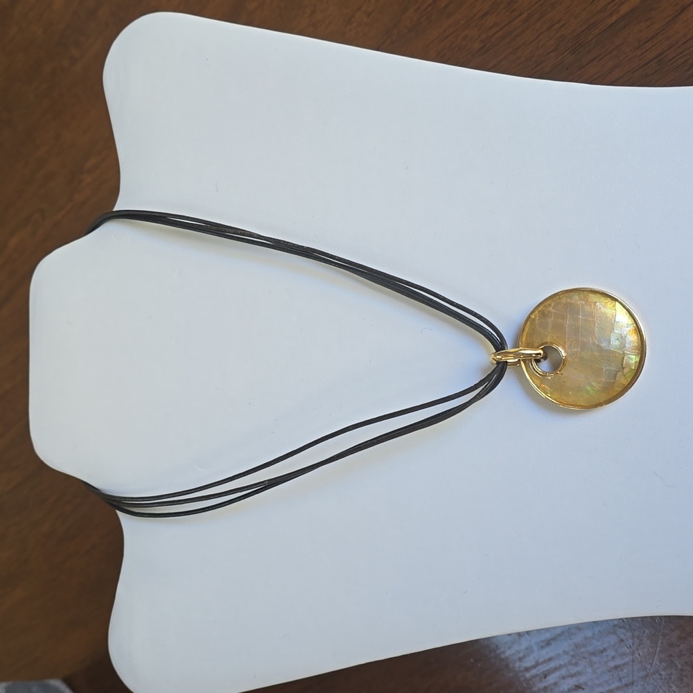 Lia Sophia Golden shell disc necklace with earrings.